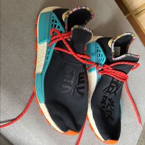 adidas Black and Teal Sneakers with Red Accents .